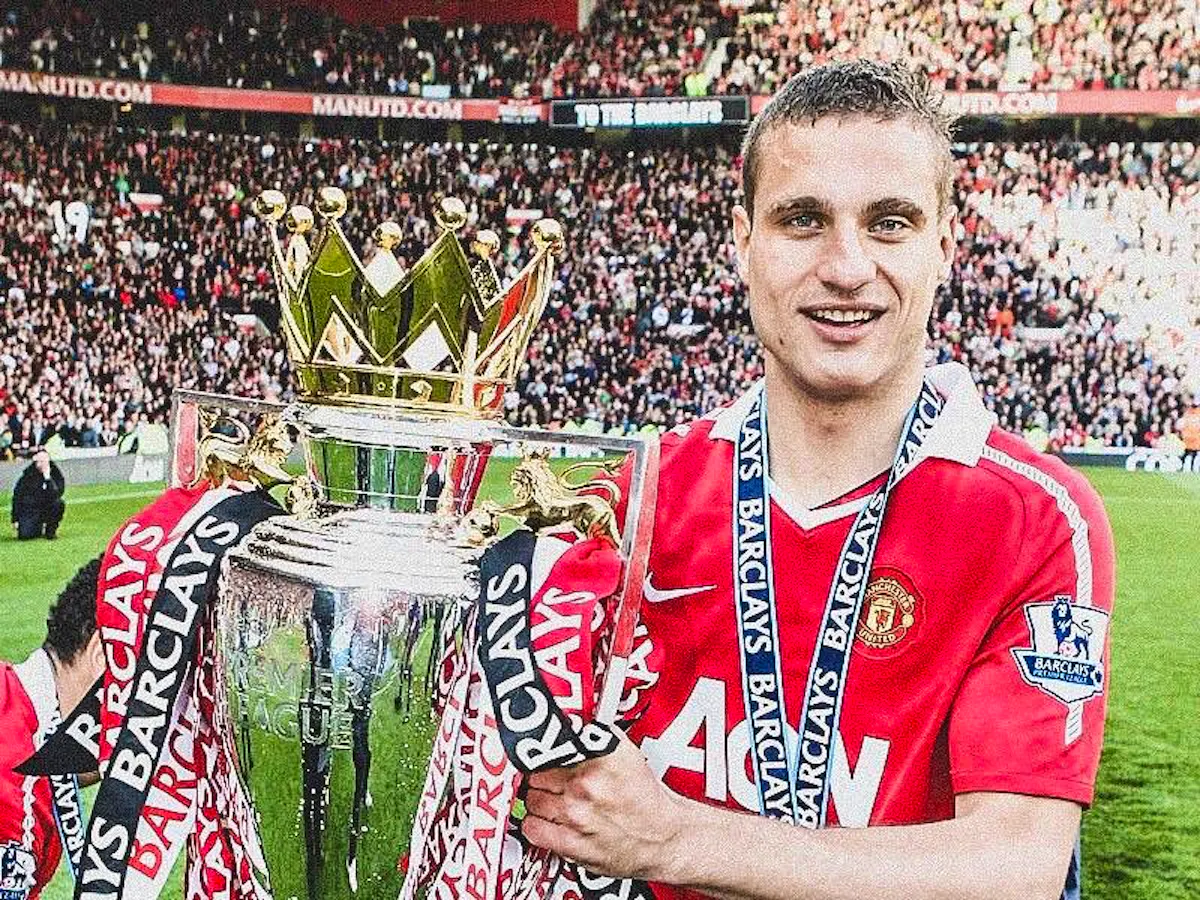 Nemanja Vidic holds the Premier League trophy after winning with Manchester United.
