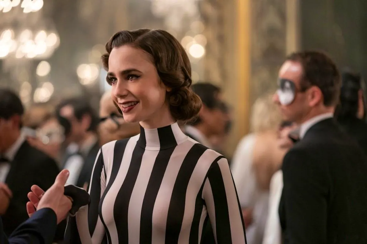 Emily (Lily Collins), dressed in black and white stripes, just like Beetlejuice