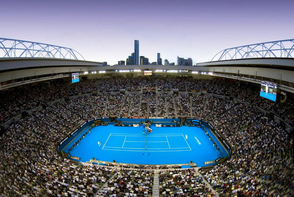 The Rod Laver Arena, the main court at Melbourne Park, with a match being played at dusk.