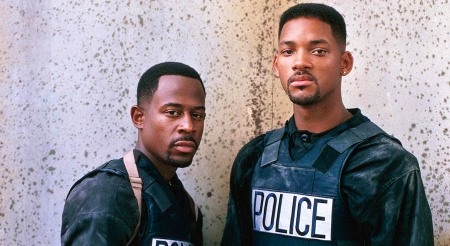 Mike (Will Smith) and Marcus (Martin Lawrence), wearing dirty riot gear, stare coolly at the camera.