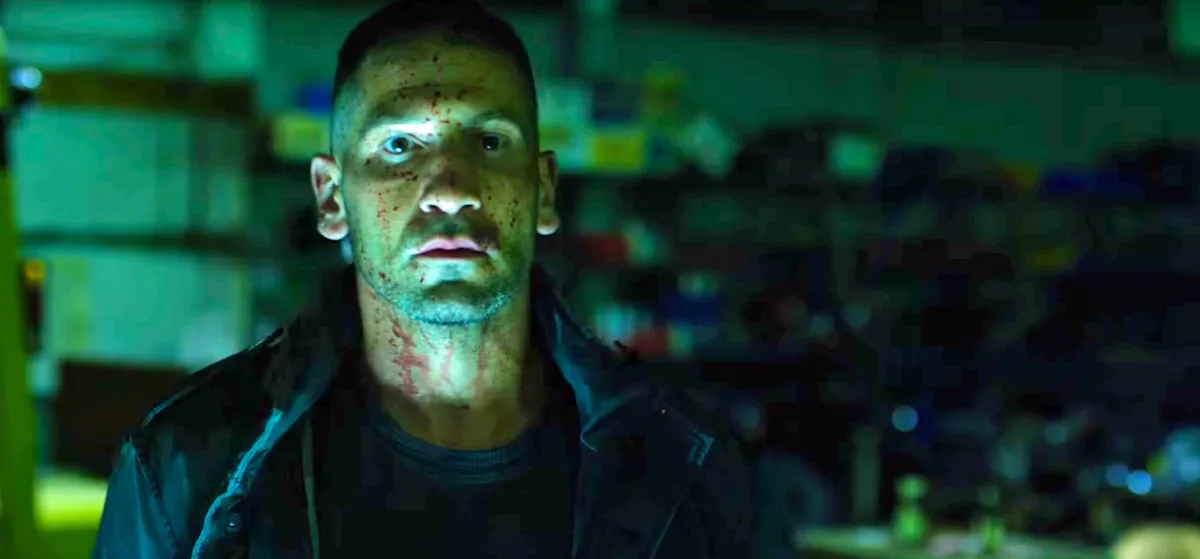 Frank Castle, the Punisher, stares at the screen, emotionless and covered in blood