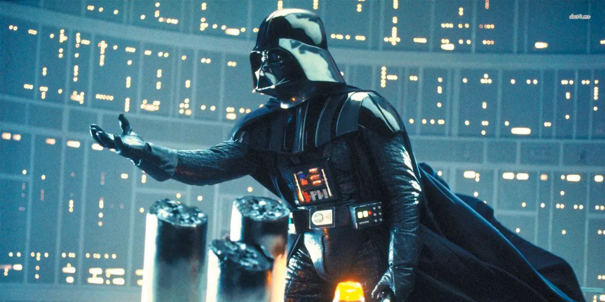 Darth Vader, a cyborg space wizard, dressed all in black, reaches out in the middle of a high tech facility