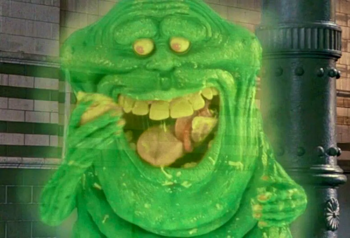 Slimer, a green blobby ghost, eating food
