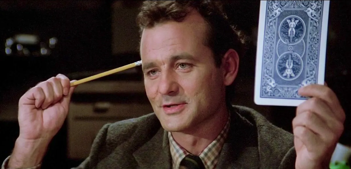 Peter Venkman holding a card for testing telepathy