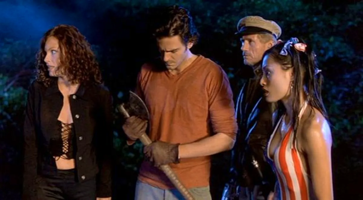 Four characters - including a woman dressed in a stars and stripes onesie and a boat captain - stand holding weapons
