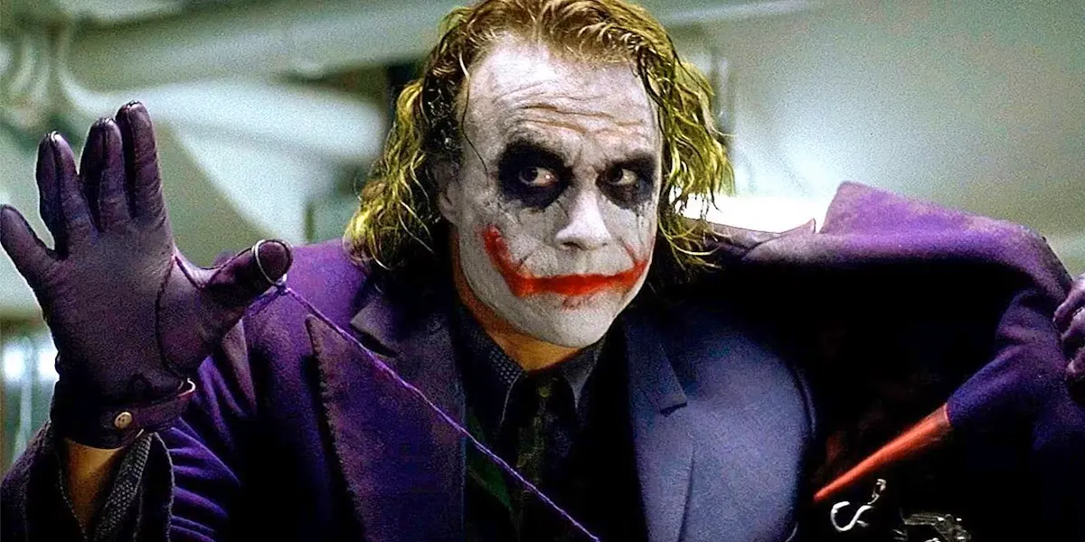 Heath Ledger, as the Joker, threateningly pulling the string attached to the grenade in his jacket pocket