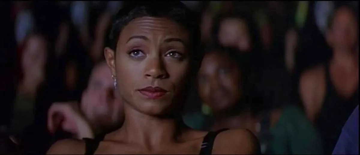 Maureen, played by Jada Pinkett Smith, in a cinema looking unimpressed