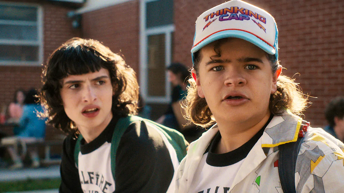 Two '80s kids look worriedly at something offscreen - probably a monster
